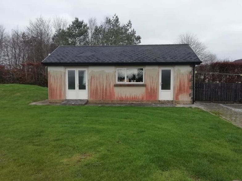 Building covered in red mold