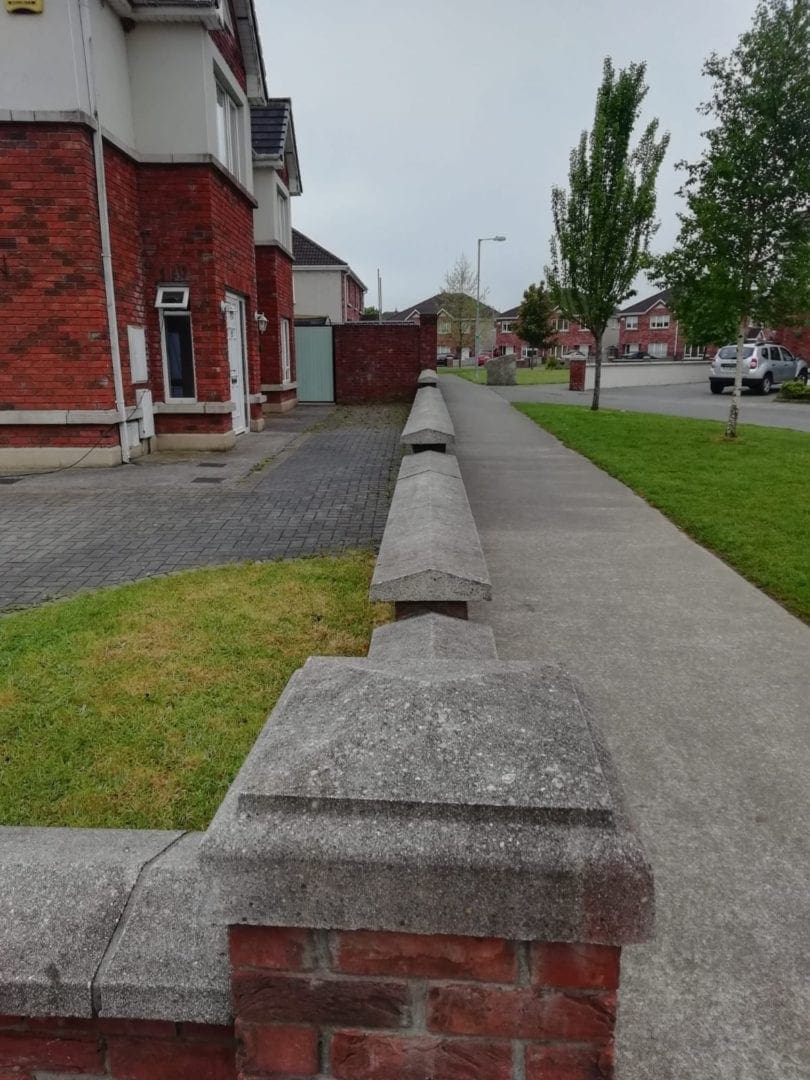 Driveway piers and wall before cleaning