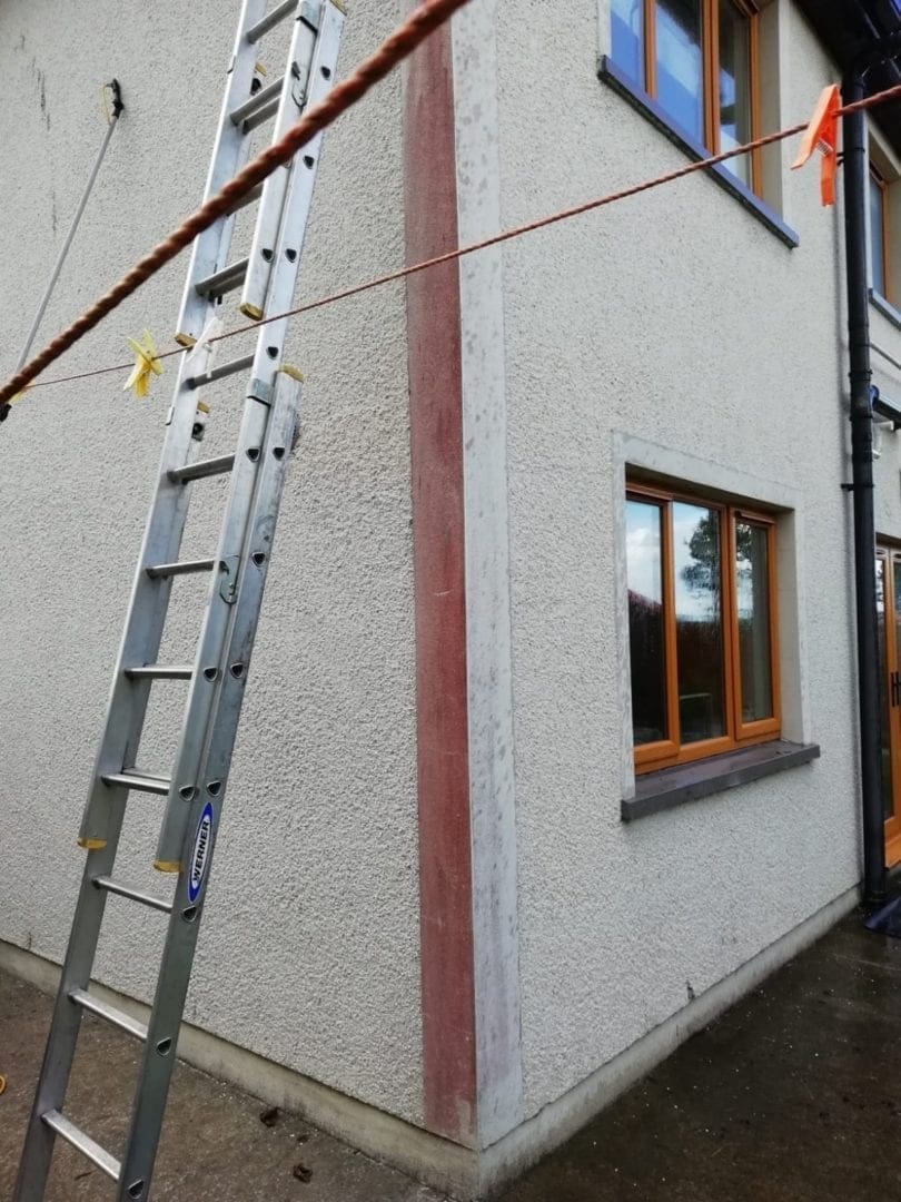 Halfway through the wall cleaning job you can see the red mold is disappearing