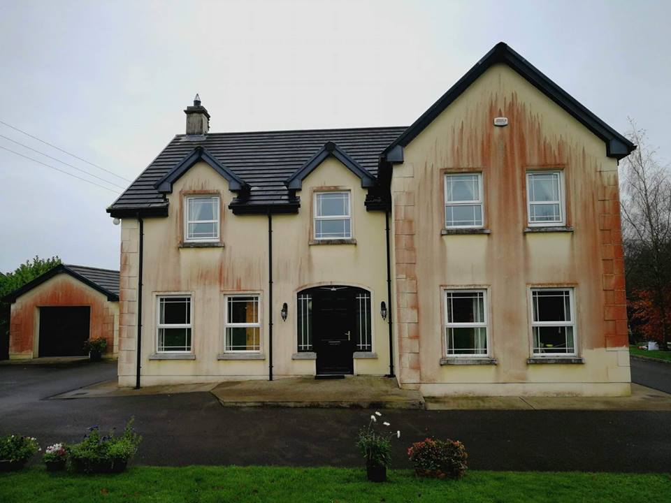 House with red mold window cleaning