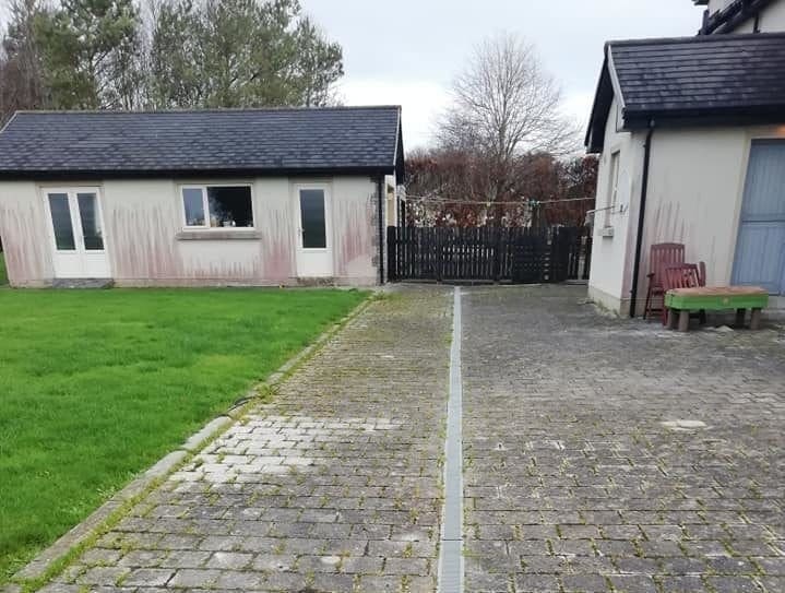 House with red mold and dirty patio